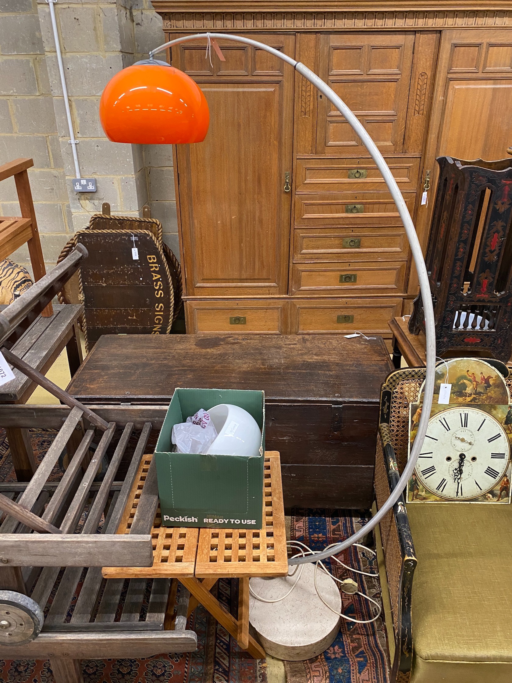 A 1960's adjustable chromium arc floor lamp with orange shade, height 175cm and a spare white shade